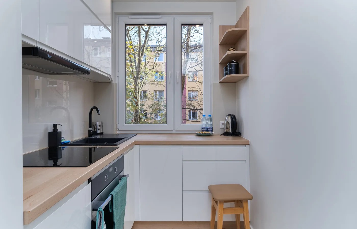 Compact bright white kitchen with visually light cabinetry and an efficient layout