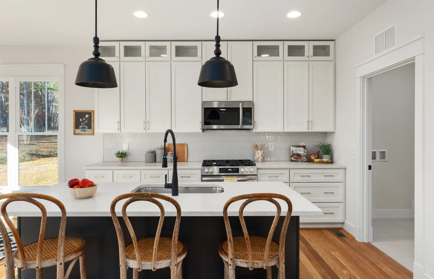 White kitchen with restrained dark accents used as controlled contrast